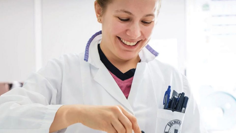 A doctor smiling and working